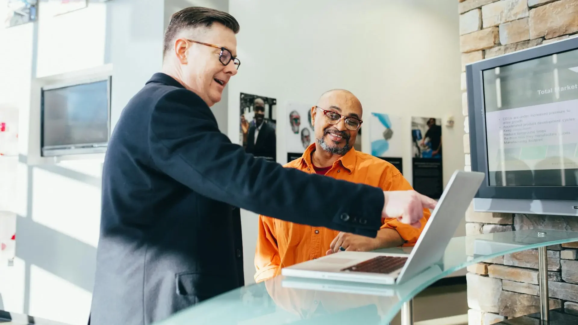 a man showing another man benefits of workflow automation